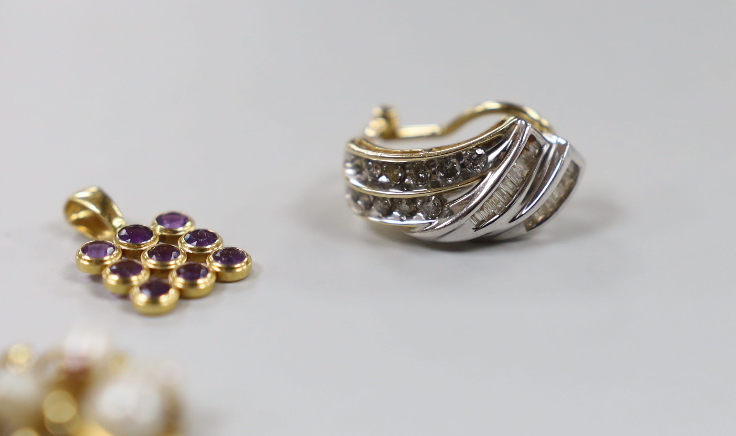 Two modern 14k and gem set pendants, one 750 and amethyst cluster set pendant and a 14k and diamond cluster set earring.